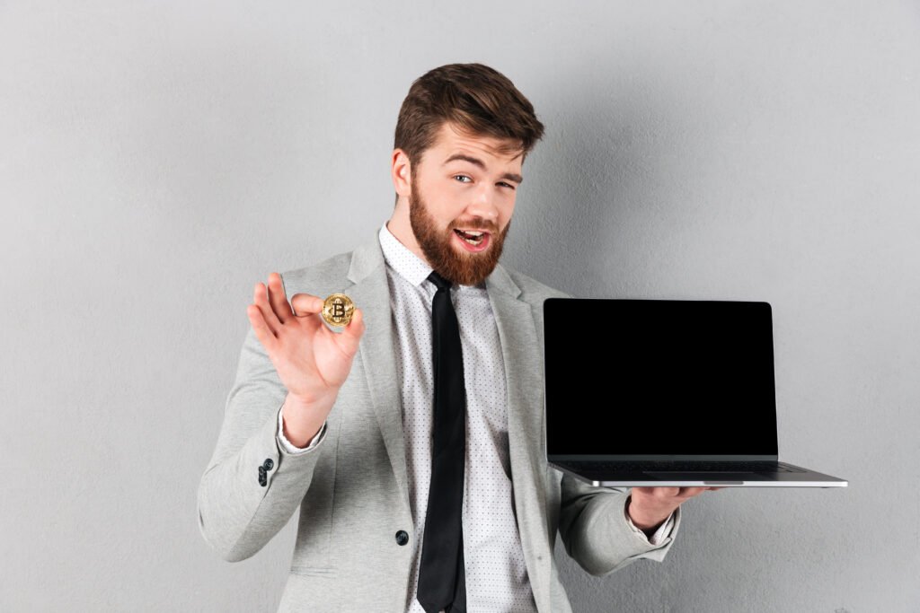 portrait of a handsome businessman holding bitcoin